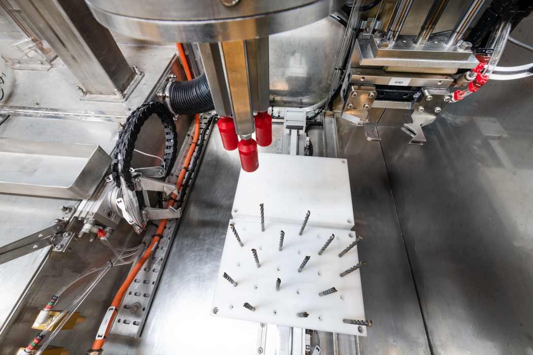 Drill bits on a pallet in the Vapormatt Oncilla automatic wet blasting machine